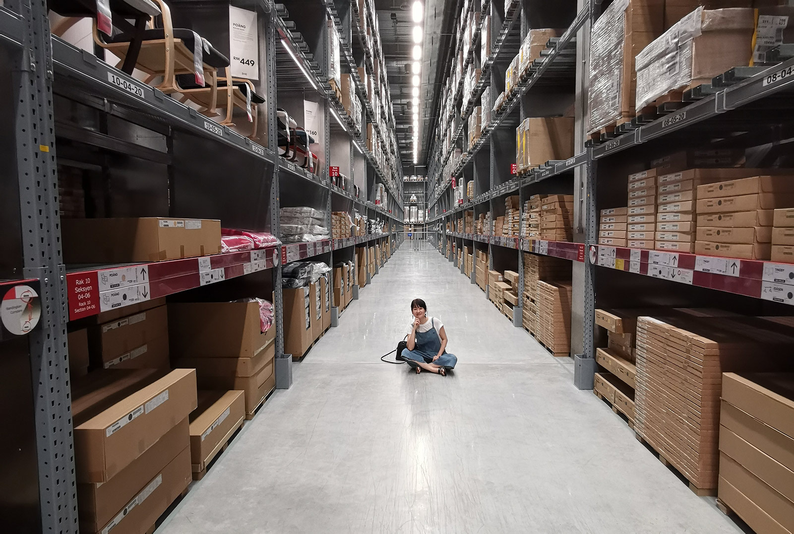 woman sitting on ground in warehouse