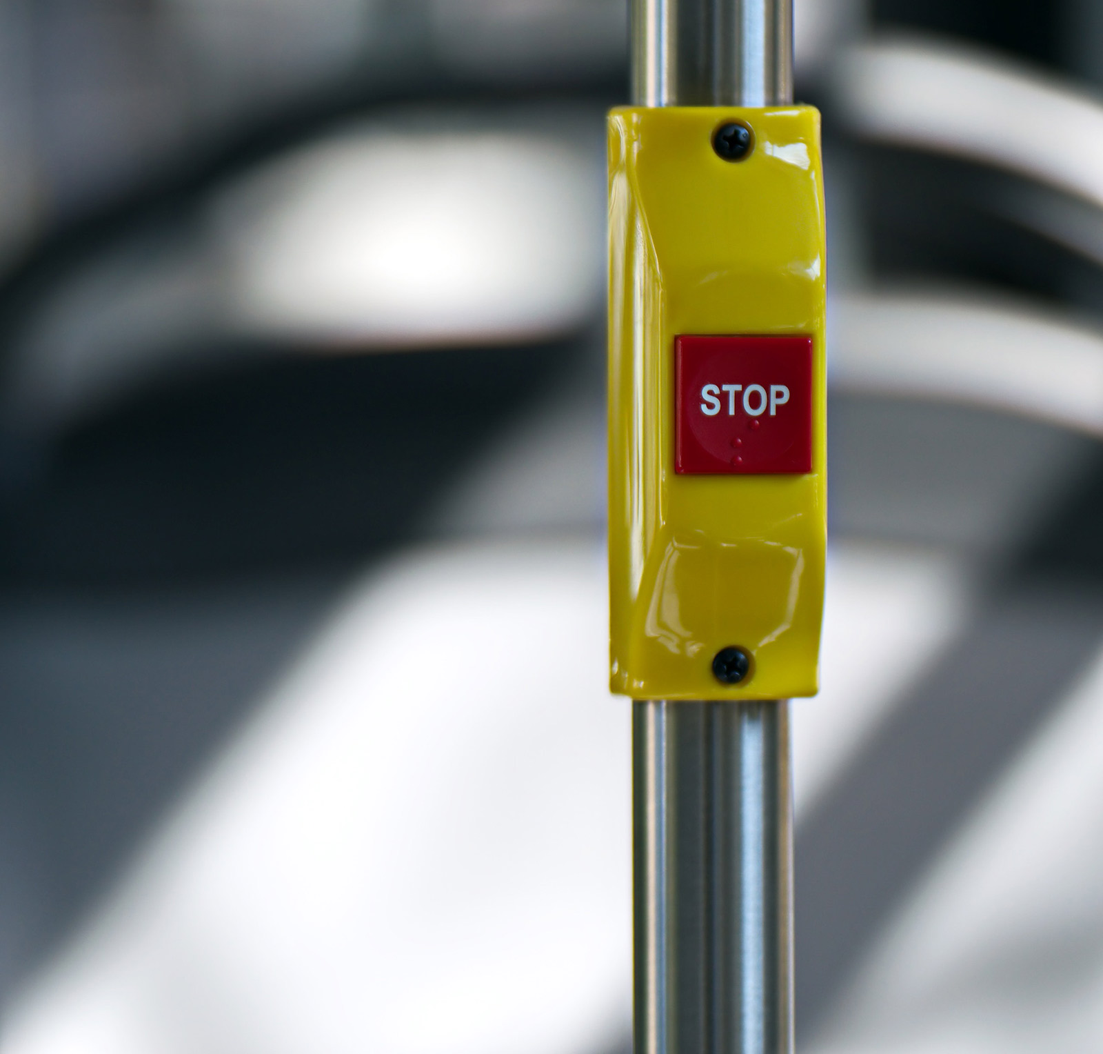 a stop button on a bus rail