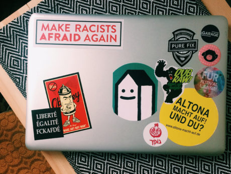 a laptop with lots of stickers on it