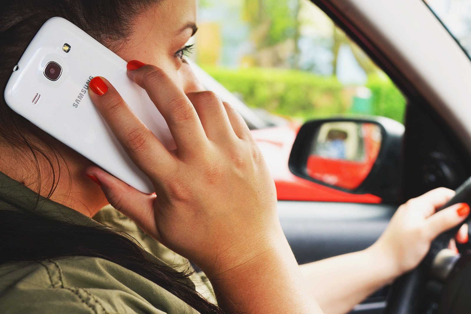woman driving while talking on phone