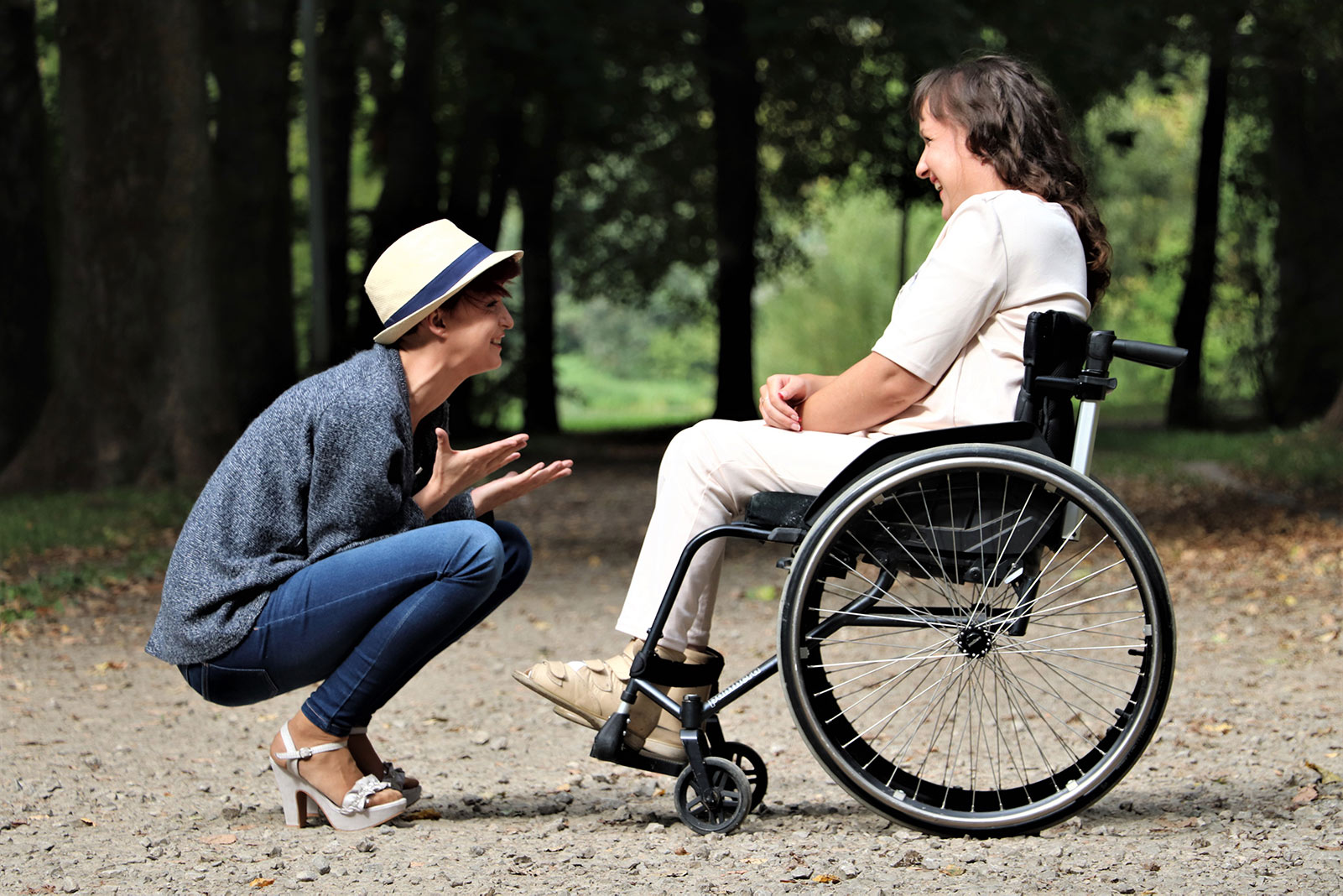woman in wheelchair speaking with man